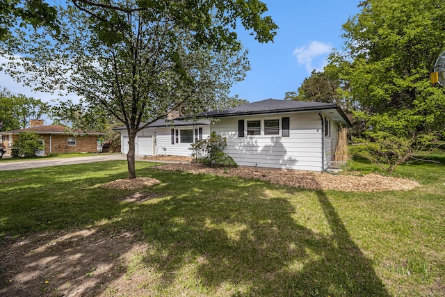 view of front of property with driveway, an attached garage, and a front yard