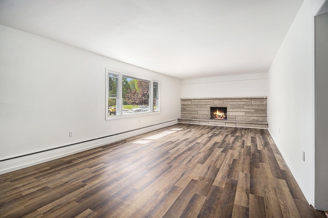 unfurnished living room with wood finished floors, a baseboard radiator, a stone fireplace, and baseboards