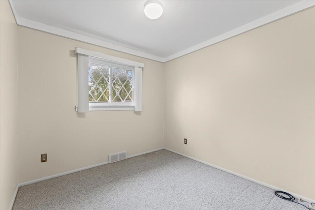 carpeted spare room featuring baseboards