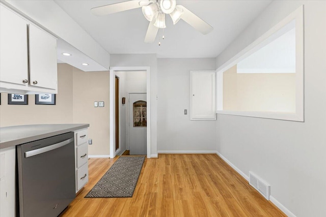 kitchen with stainless steel dishwasher, white cabinetry, light wood-type flooring, a ceiling fan, and light countertops