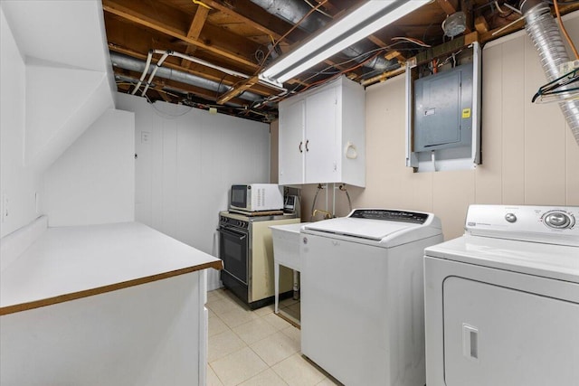 clothes washing area with washer and dryer, cabinet space, and electric panel