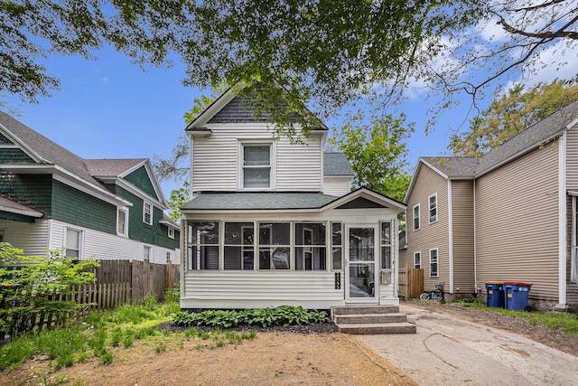 2145 Horton Ave SE, Grand Rapids, MI 49507 - view of front of property featuring a sunroom, a shingled roof, and fence