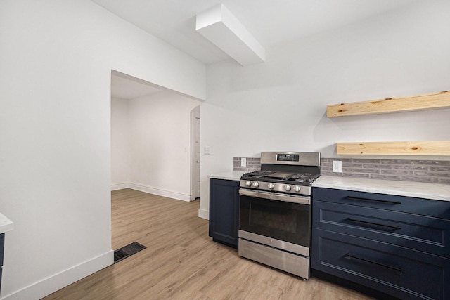2145 Horton Ave SE, Grand Rapids, MI 49507 - kitchen featuring stainless steel range with gas cooktop, baseboards, light wood finished floors, and tasteful backsplash