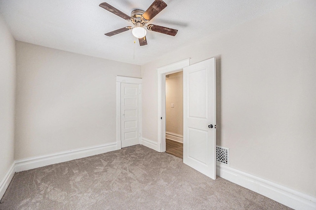 2145 Horton Ave SE, Grand Rapids, MI 49507 - unfurnished bedroom featuring carpet floors, ceiling fan, and baseboards