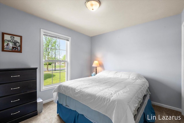carpeted bedroom featuring baseboards