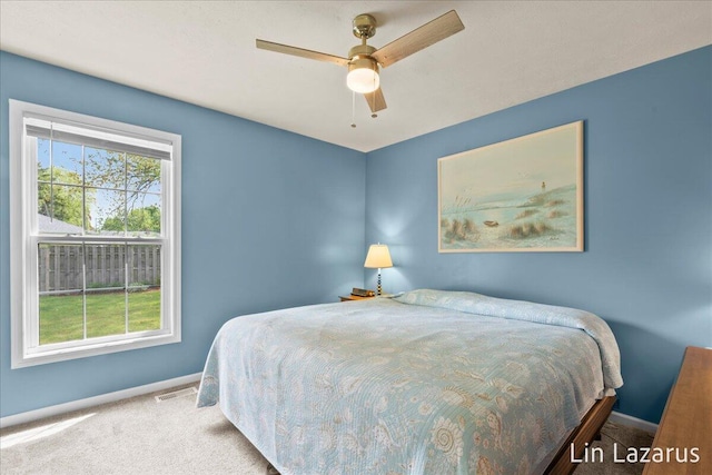 bedroom with carpet, baseboards, and ceiling fan