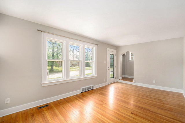 223 N Edison, Royal Oak, MI 48067 - spare room featuring arched walkways, light wood-type flooring, and baseboards
