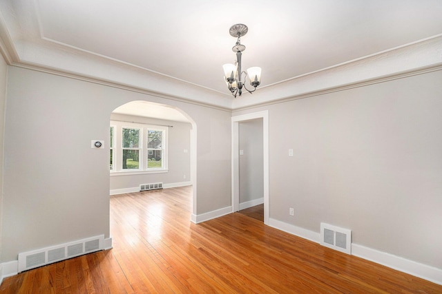 223 N Edison, Royal Oak, MI 48067 - unfurnished room with a chandelier, arched walkways, light wood-style floors, baseboards, and ornamental molding