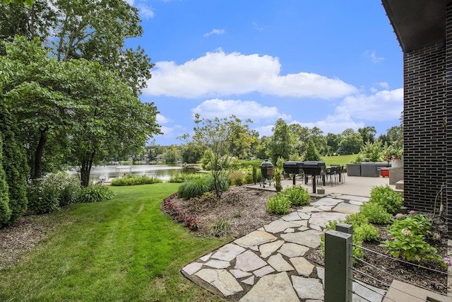 1950 Robinson Rd SE, East Grand Rapids, MI 49506 - view of green lawn featuring a water view and a patio