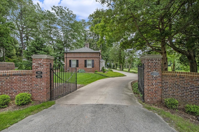 1950 Robinson Rd SE, East Grand Rapids, MI 49506 - view of concrete driveway featuring a gate and a gated entry