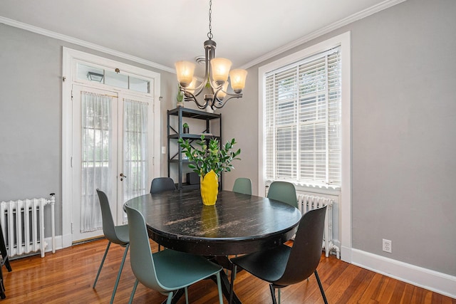 1950 Robinson Rd SE, East Grand Rapids, MI 49506 - dining space with radiator heating unit, a chandelier, ornamental molding, wood finished floors, and baseboards