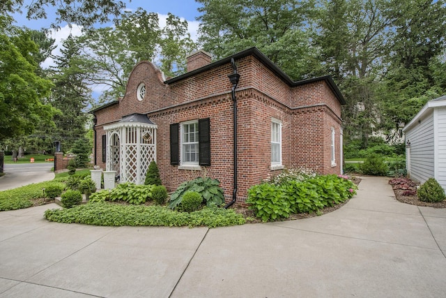 1950 Robinson Rd SE, East Grand Rapids, MI 49506 - view of side of property with brick siding and a chimney