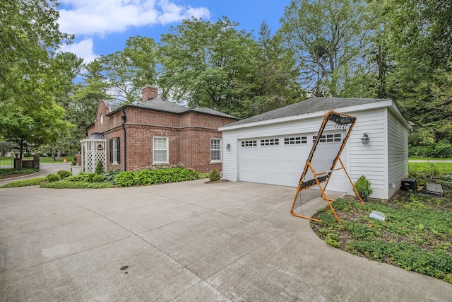 1950 Robinson Rd SE, East Grand Rapids, MI 49506 - view of front facade featuring a detached garage, brick siding, and a chimney
