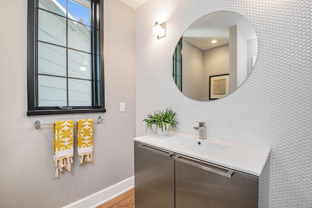 1950 Robinson Rd SE, East Grand Rapids, MI 49506 - bathroom featuring baseboards, wood finished floors, and vanity