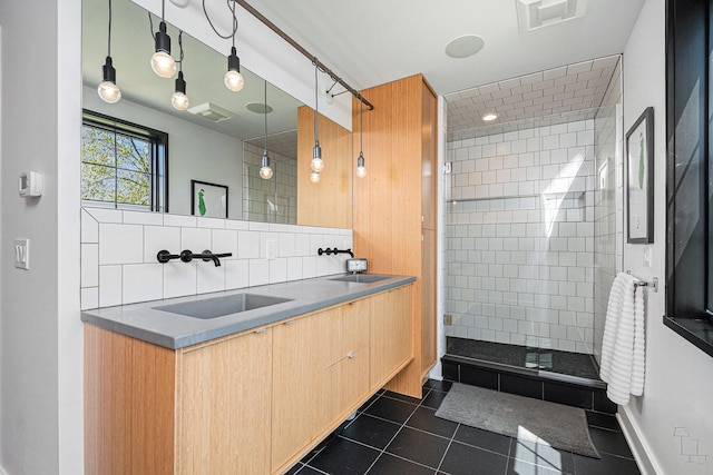 1950 Robinson Rd SE, East Grand Rapids, MI 49506 - full bathroom with tile patterned floors, a shower stall, double vanity, and backsplash