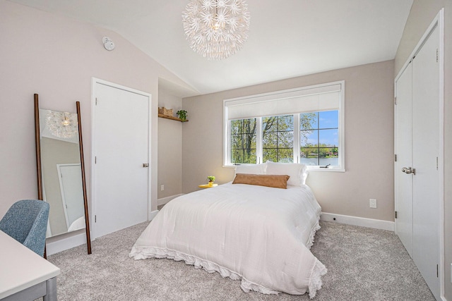 1950 Robinson Rd SE, East Grand Rapids, MI 49506 - bedroom featuring light colored carpet, vaulted ceiling, a chandelier, and baseboards