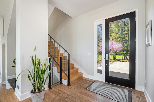 1950 Robinson Rd SE, East Grand Rapids, MI 49506 - entrance foyer with stairway, hardwood / wood-style flooring, and baseboards