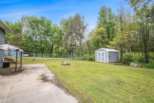 21164 Calvin Hill St, Cassopolis, MI 49031 - view of yard with a storage unit, central AC, a fire pit, an outdoor structure, and asphalt driveway