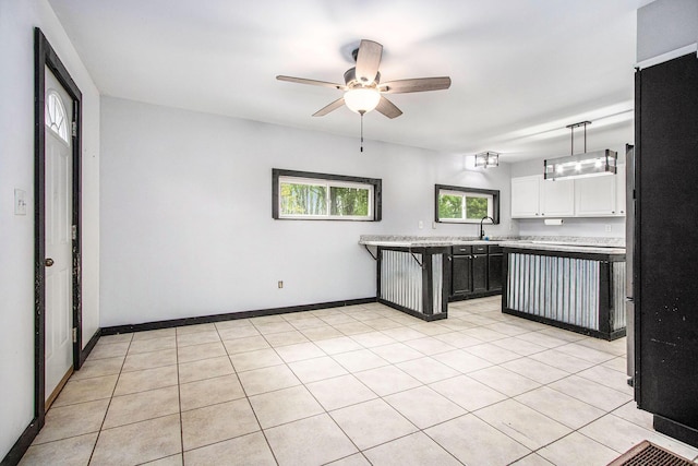 21164 Calvin Hill St, Cassopolis, MI 49031 - kitchen with light countertops, a ceiling fan, freestanding refrigerator, a sink, and white cabinets