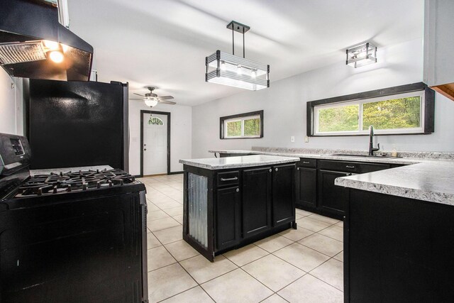 21164 Calvin Hill St, Cassopolis, MI 49031 - kitchen featuring black range with gas cooktop, dark cabinetry, island exhaust hood, a sink, and light tile patterned flooring