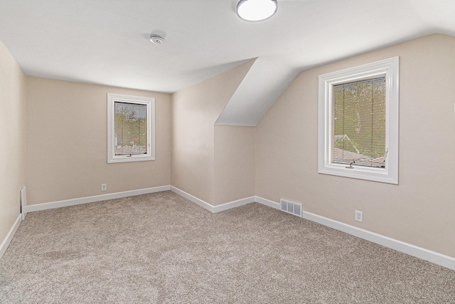 bonus room with carpet, vaulted ceiling, and baseboards