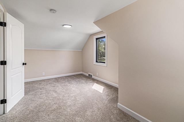 bonus room with carpet, lofted ceiling, and baseboards