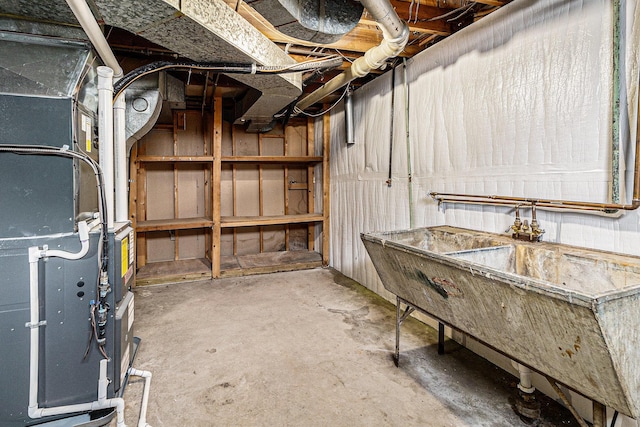 unfinished basement featuring heating unit and a sink