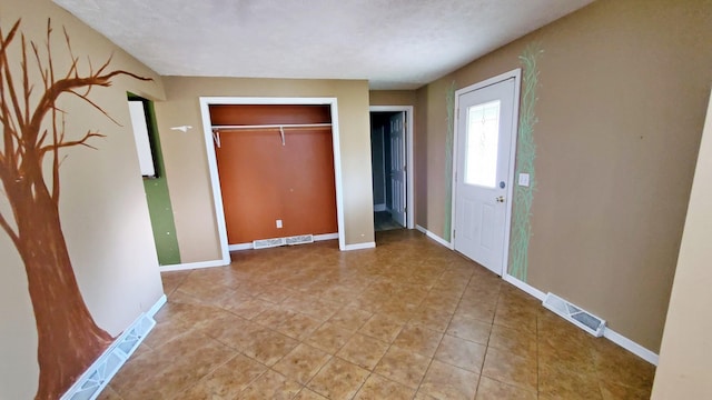 365 Quarterline St, Newaygo, MI 49337 - unfurnished bedroom featuring a closet, light tile patterned flooring, and baseboards