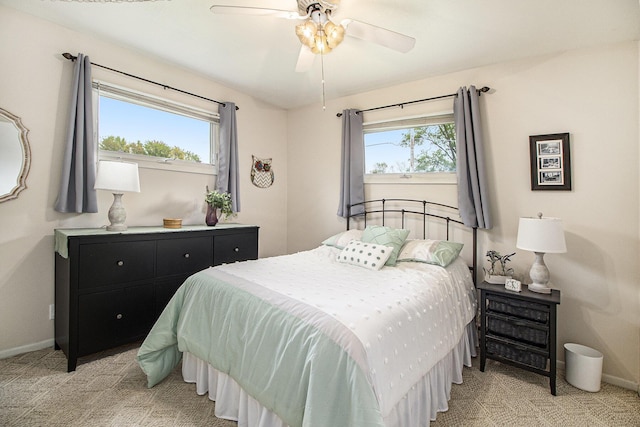bedroom featuring baseboards, light carpet, and a ceiling fan