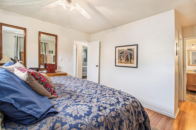 bedroom with light wood finished floors, connected bathroom, baseboards, and ceiling fan