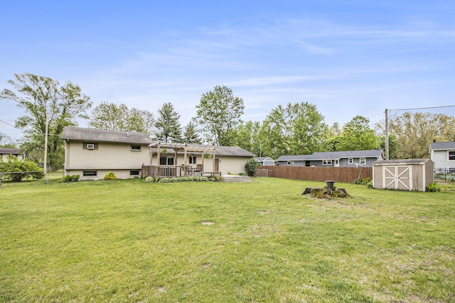 view of yard featuring a pergola, a shed, an outdoor structure, and a deck