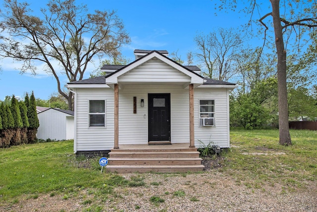 2228 Regent St, Kalamazoo, MI 49004 - bungalow-style home with a front lawn, a shingled roof, and cooling unit