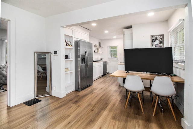 2228 Regent St, Kalamazoo, MI 49004 - kitchen with stainless steel appliances, open shelves, light wood-style floors, white cabinetry, and recessed lighting
