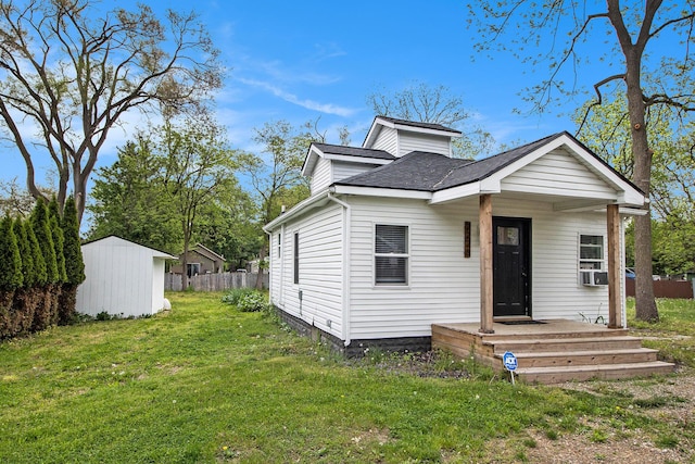 2228 Regent St, Kalamazoo, MI 49004 - bungalow featuring roof with shingles, an outbuilding, cooling unit, and a storage unit