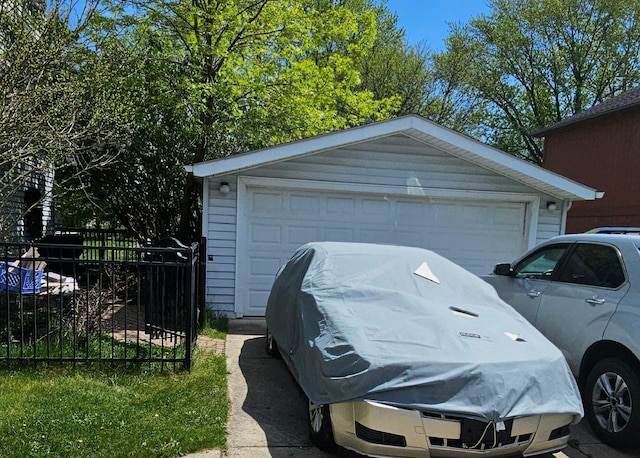 detached garage featuring fence