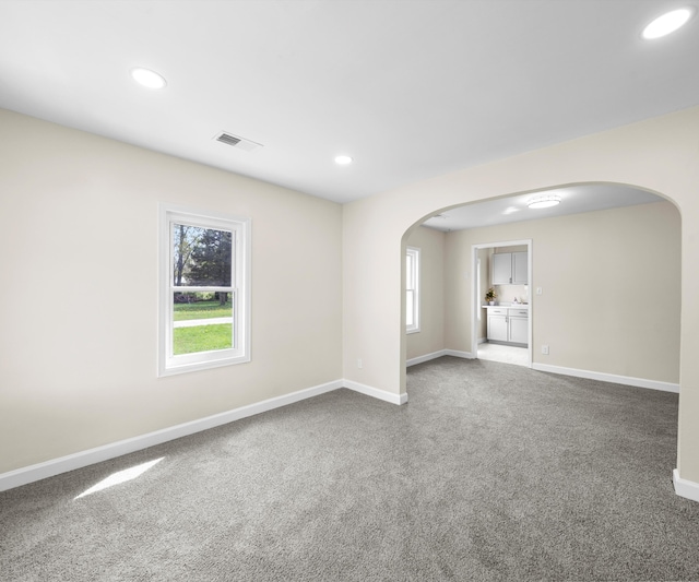 24108 Martinsville Rd, Belleville, MI 48111 - unfurnished room with arched walkways, baseboards, carpet floors, and recessed lighting