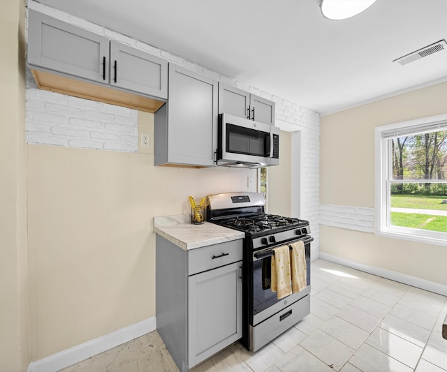 24108 Martinsville Rd, Belleville, MI 48111 - kitchen with appliances with stainless steel finishes, gray cabinets, baseboards, light countertops, and light marble finish flooring