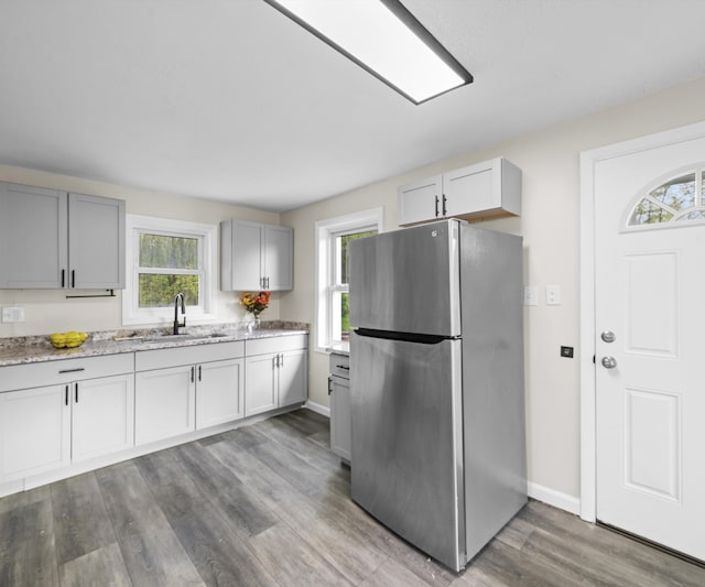 24108 Martinsville Rd, Belleville, MI 48111 - kitchen featuring freestanding refrigerator, a sink, wood finished floors, and baseboards