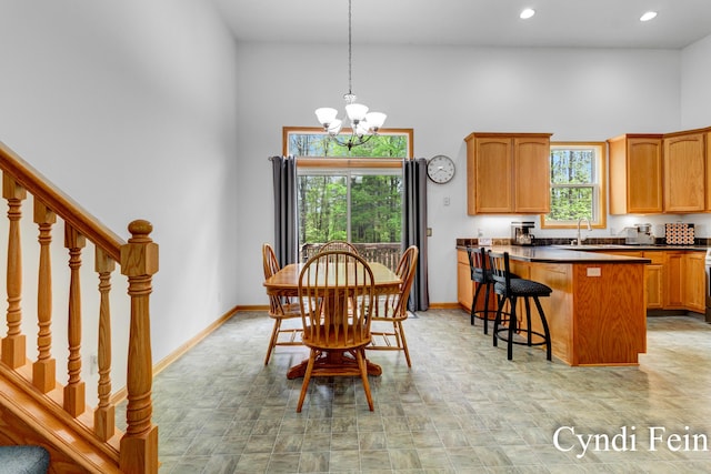 2970 Braden Blvd, Dorr, MI 49323 - dining space featuring baseboards, a chandelier, a high ceiling, stairs, and recessed lighting