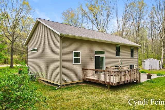 2970 Braden Blvd, Dorr, MI 49323 - back of property with a shed, a lawn, an outdoor structure, a deck, and roof with shingles