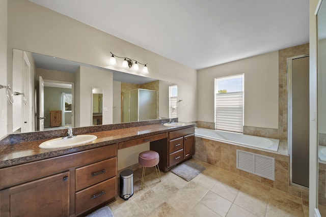 510 Edward J St, Clinton, MI 49236 - full bathroom with a shower stall, a bath, double vanity, and tile patterned flooring
