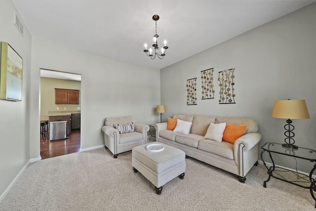 510 Edward J St, Clinton, MI 49236 - carpeted living room with baseboards and a chandelier