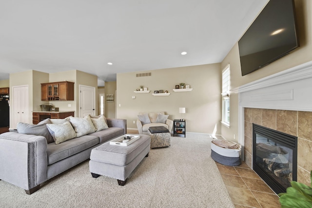 510 Edward J St, Clinton, MI 49236 - living area with a tile fireplace, light tile patterned floors, light carpet, and recessed lighting