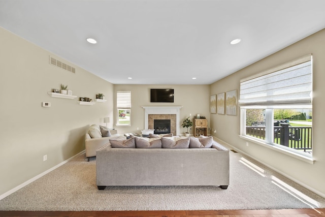 510 Edward J St, Clinton, MI 49236 - living room featuring a tile fireplace, baseboards, recessed lighting, and carpet floors