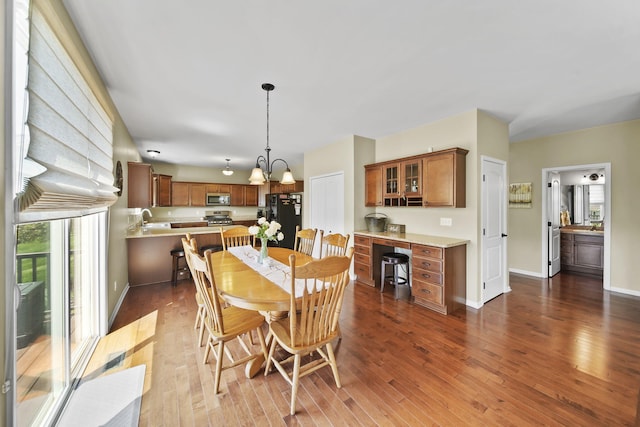 510 Edward J St, Clinton, MI 49236 - dining room featuring dark wood-type flooring, a chandelier, and baseboards