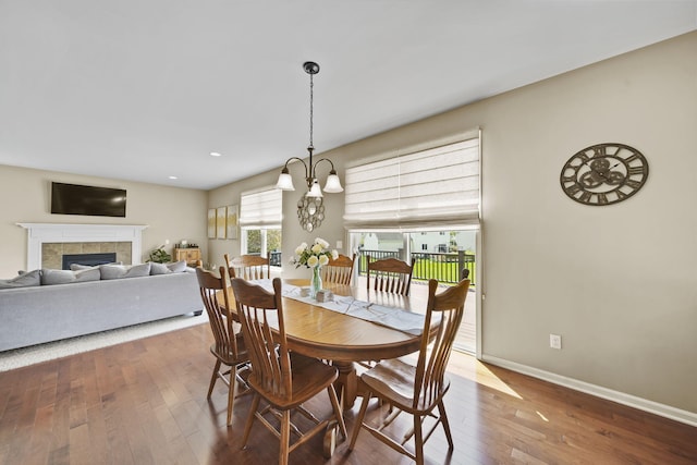 510 Edward J St, Clinton, MI 49236 - dining area with hardwood / wood-style flooring, a tile fireplace, baseboards, recessed lighting, and a chandelier