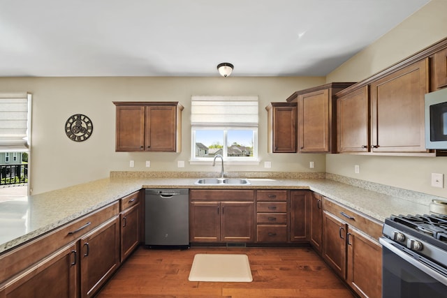 510 Edward J St, Clinton, MI 49236 - kitchen with stainless steel dishwasher, a sink, range with gas stovetop, and dark wood-style floors