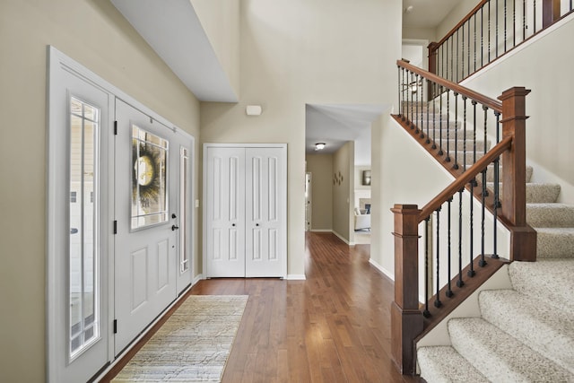 510 Edward J St, Clinton, MI 49236 - entrance foyer featuring a high ceiling, hardwood / wood-style flooring, stairway, and baseboards