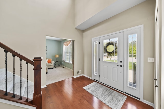 510 Edward J St, Clinton, MI 49236 - foyer entrance with dark wood-type flooring, stairway, and baseboards