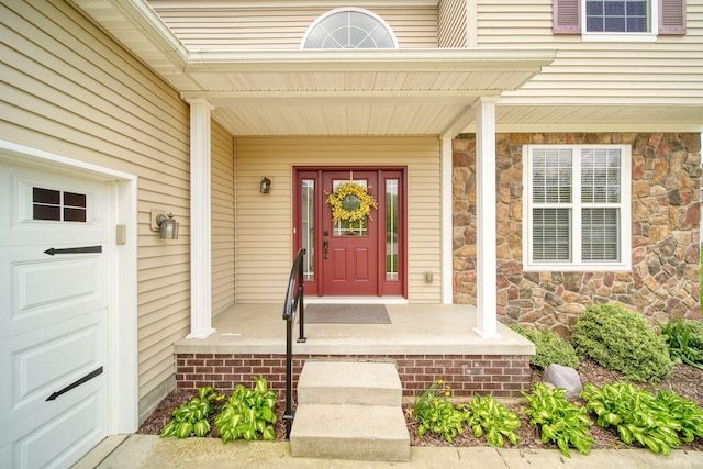510 Edward J St, Clinton, MI 49236 - doorway to property with stone siding and covered porch